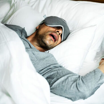 Man sleeping with sleep apnea and snoring